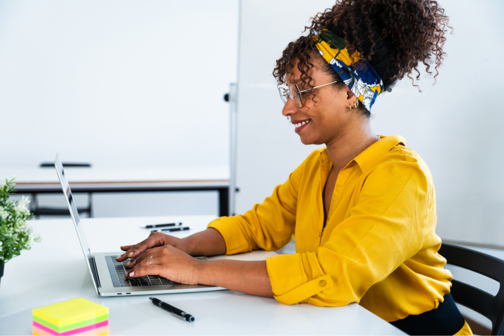 Woman sitting at desk using a laptop